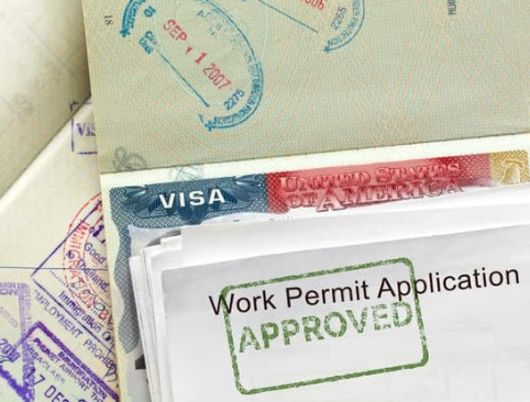 A stack of immigration paperwork for employment authori
